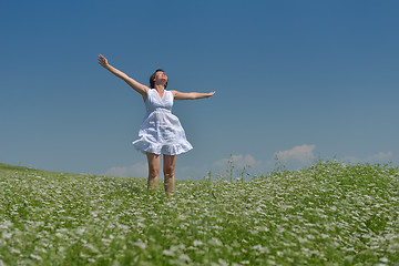 Image showing Young happy woman in green field