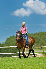 Image showing happy woman  ride  horse