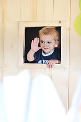 Image showing happy child in a window