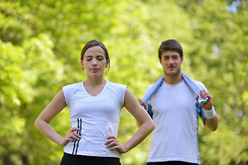 Image showing Couple doing stretching exercise  after jogging