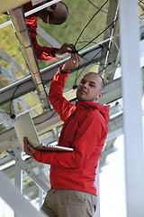 Image showing engineer using laptop at solar panels plant field