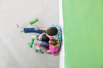 Image showing happy smiling woman painting interior of house