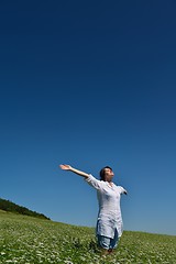 Image showing Young happy woman in green field