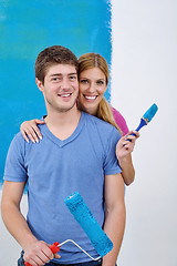 Image showing happy couple paint wall at new home