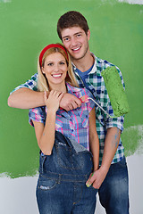 Image showing happy couple paint wall at new home