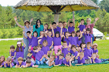 Image showing happy kids group with teacher in nature