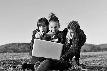 Image showing group of teens working on laptop outdoor