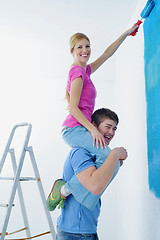 Image showing happy couple paint wall at new home