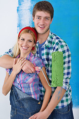 Image showing happy couple paint wall at new home