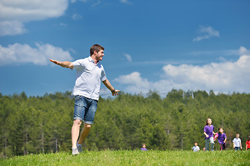 Image showing happy kids group with teacher in nature