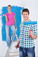 Image showing happy couple paint wall at new home