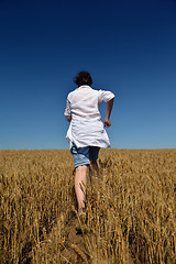 Image showing young woman in wheat field at summer