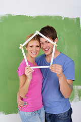 Image showing happy couple paint wall at new home