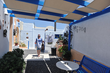 Image showing Greek woman on the streets of Oia, Santorini, Greece