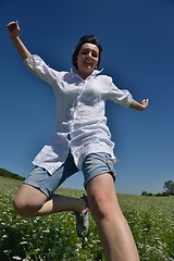 Image showing Young happy woman in green field