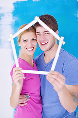 Image showing happy couple paint wall at new home