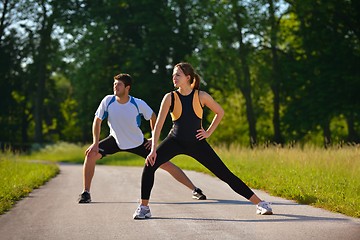 Image showing Couple doing stretching exercise  after jogging