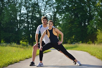 Image showing Couple doing stretching exercise  after jogging