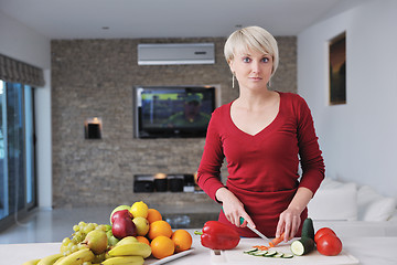 Image showing happy  beautiful blonde  woman prepare food in  the kitchen