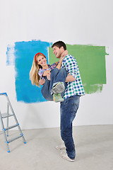 Image showing happy couple paint wall at new home