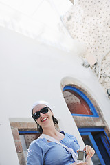 Image showing Greek woman on the streets of Oia, Santorini, Greece