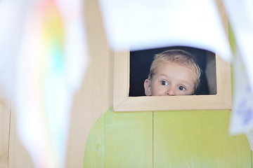 Image showing happy child in a window