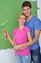 Image showing happy couple paint wall at new home