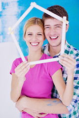 Image showing happy couple paint wall at new home