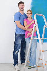 Image showing happy couple paint wall at new home