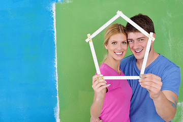 Image showing happy couple paint wall at new home