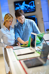 Image showing Young couple in consumer electronics store