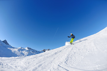 Image showing skiing on fresh snow at winter season at beautiful sunny day