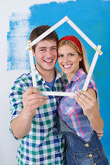 Image showing happy couple paint wall at new home