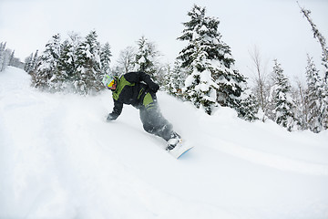 Image showing snowboarder on fresh deep snow