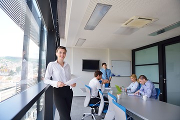 Image showing business woman with her staff in background at office