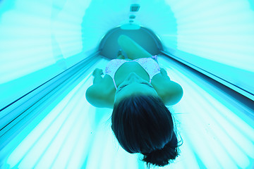 Image showing Beautiful young woman tanning in solarium