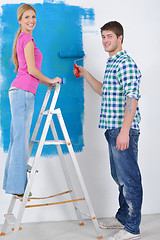 Image showing happy couple paint wall at new home