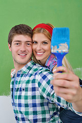 Image showing happy couple paint wall at new home