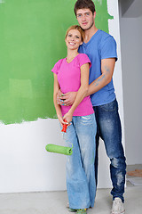 Image showing happy couple paint wall at new home