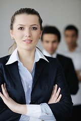 Image showing business woman standing with her staff in background