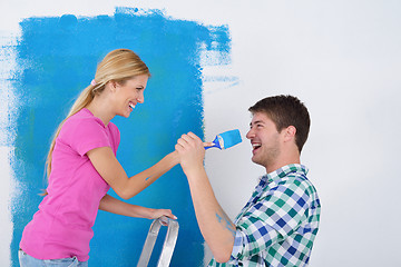 Image showing happy couple paint wall at new home