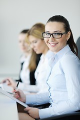 Image showing business woman standing with her staff in background