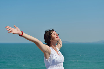 Image showing happy young woman with spreading arms to sky