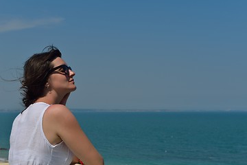 Image showing young woman with spreading arms to sky