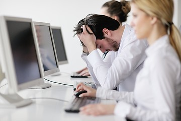 Image showing tired and depresed young business man at office