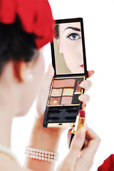 Image showing beautiful young woman applying makeup