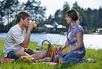 Image showing happy young couple having a picnic outdoor