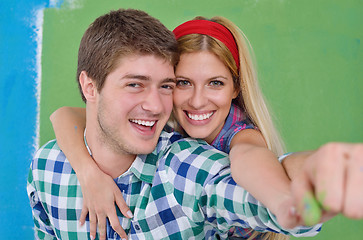 Image showing happy couple paint wall at new home