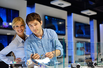 Image showing Young couple in consumer electronics store