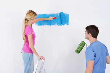 Image showing happy couple paint wall at new home